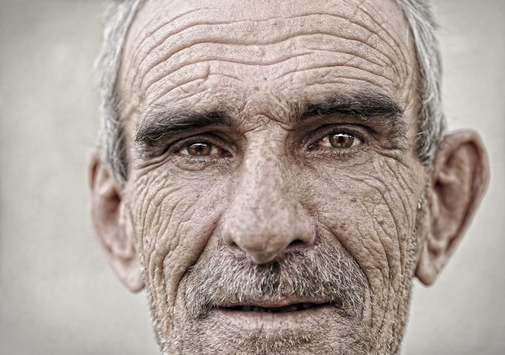 A close up of an elder man's face. Elder Financial Abuse