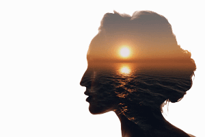A silhouette of a women's head with a sunset transposed inside. Your mind and money