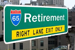 A green sign that says retirement right lane exit only truthfully guides drivers towards their 401(k) borrowing options.